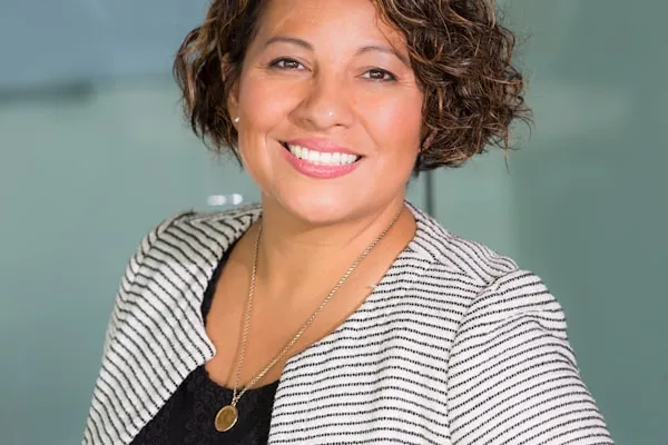 HR leader reviewing employee benefits documentation in a modern office