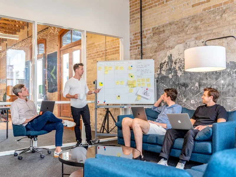 Team collaborating around a whiteboard in a bright office