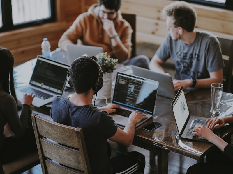 Small team working together around a table with warm natural light